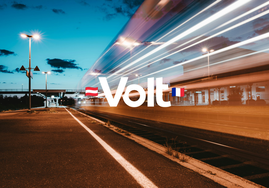 Train filant à toute vitesse dans une gare au coucher du soleil