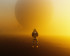 Astronaut contemplating a yellow planet