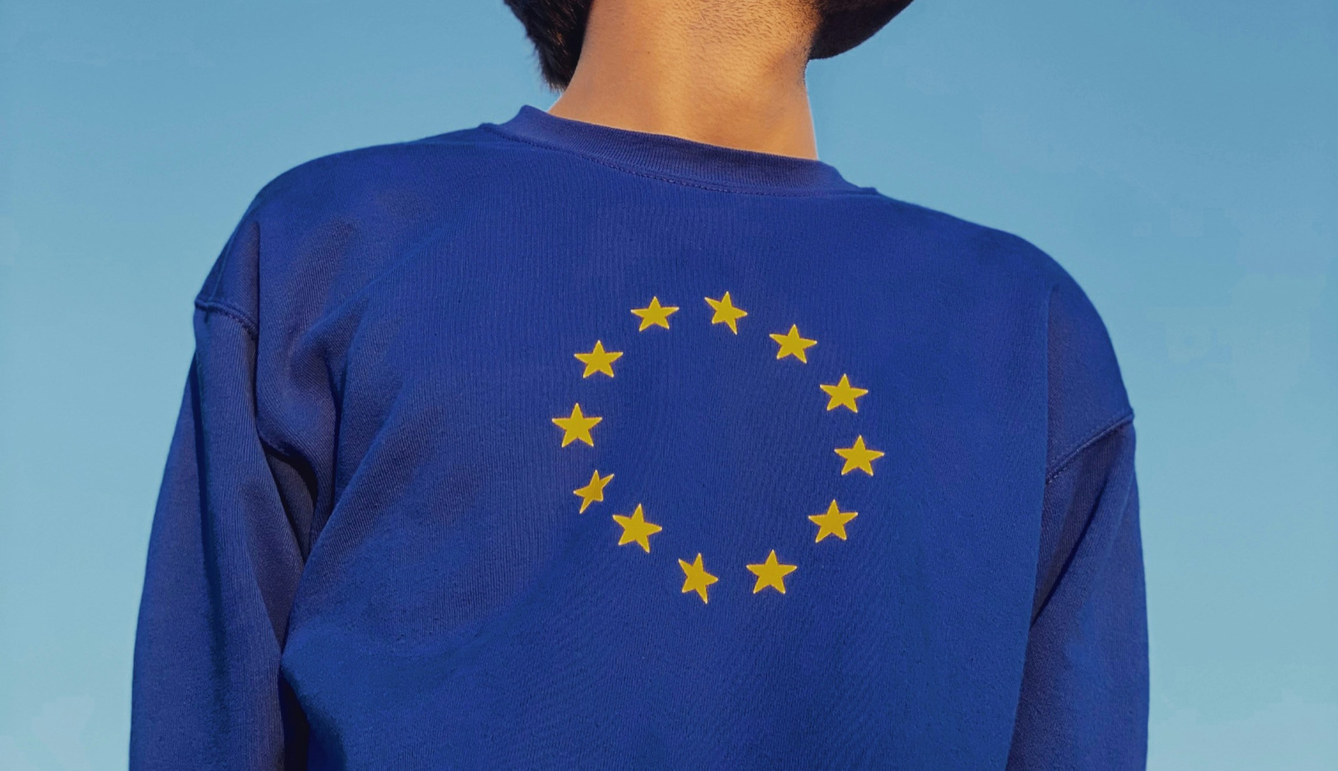 man with closed eyes and a european sweatshirt