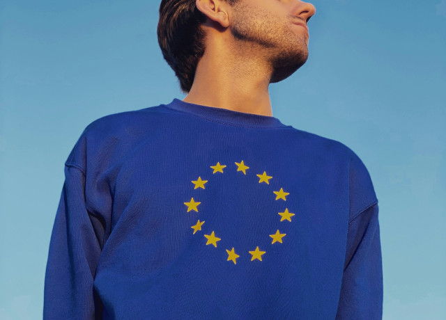 man with closed eyes and a european sweatshirt